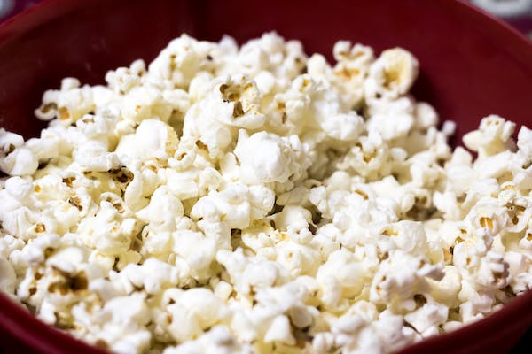 How do you clean a dirty popcorn maker?